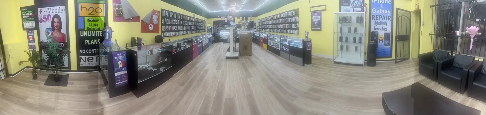 Inside Mega Wireless: phone accessories wall, display cases, unlocked phones and repair counter